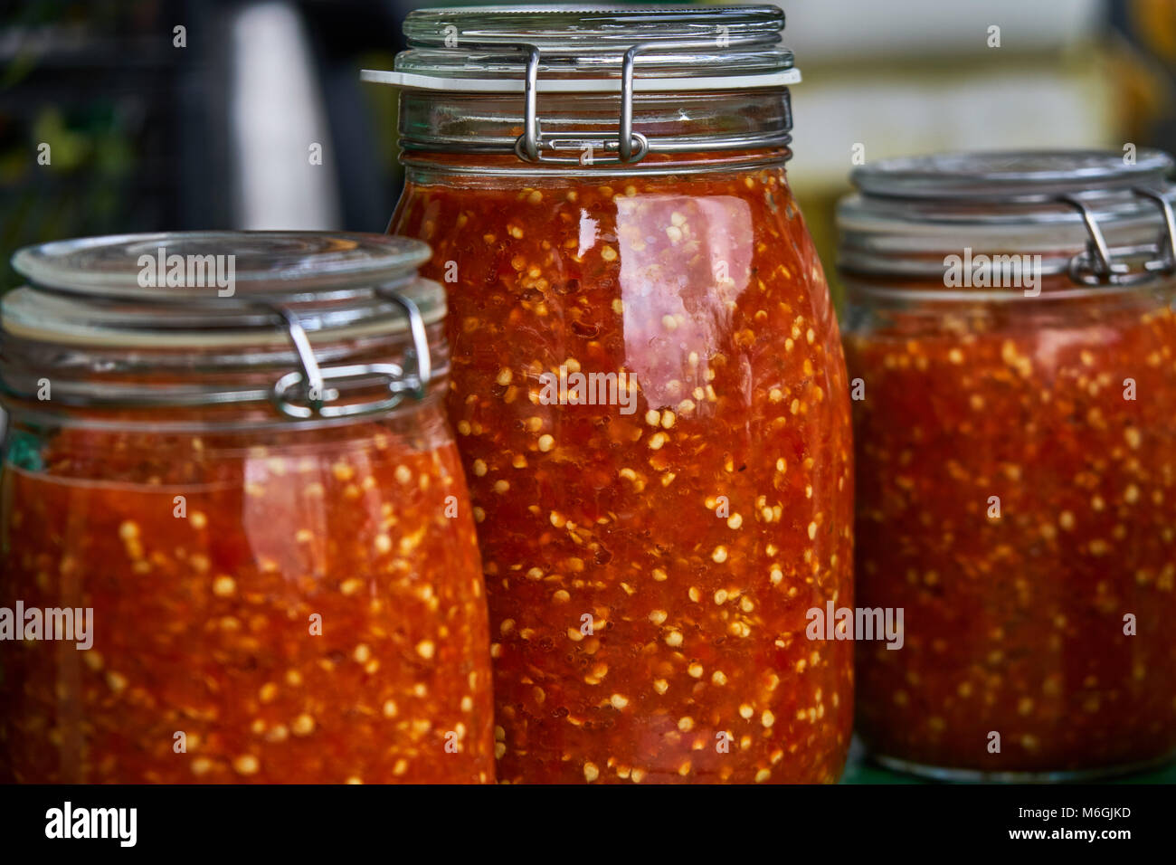 Canning the hot pepper. Glass jars with hot pepper. Grinded hot cayenne