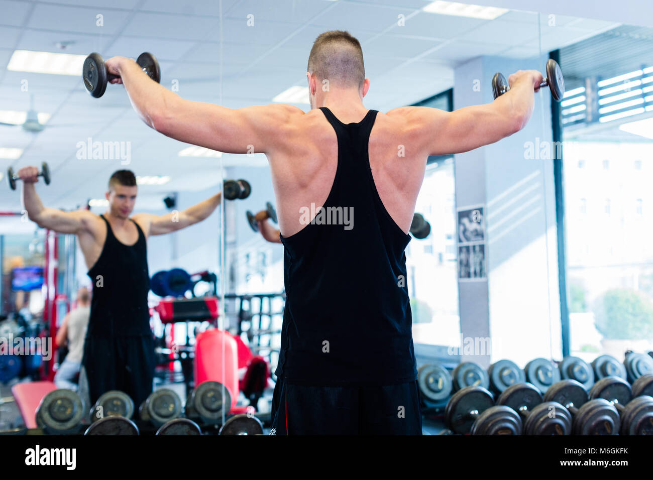 Fit woman working out at the gym with dumbbells stock photo (123574) -  YouWorkForThem