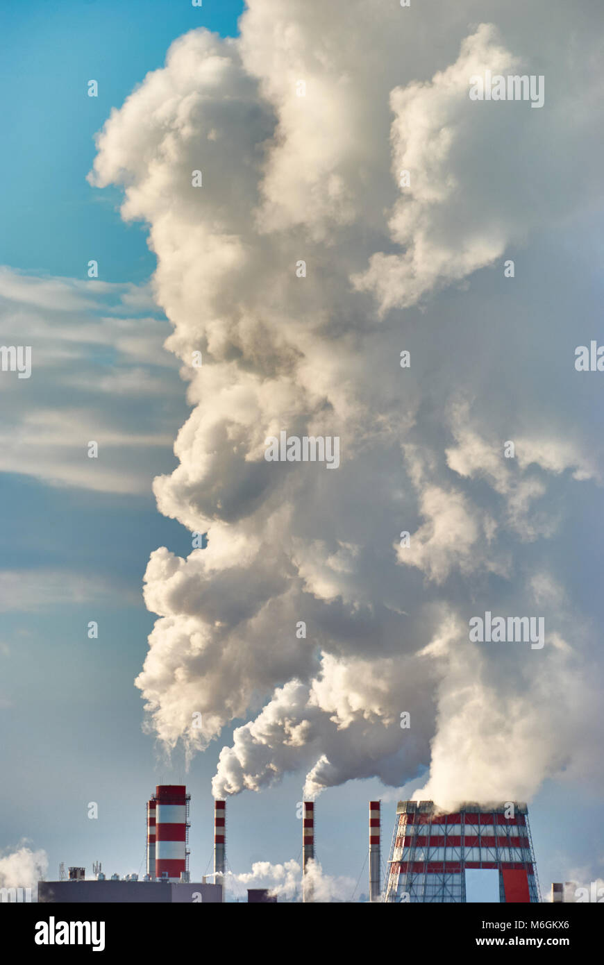 Dense steam escaping from a thermal power plant on a frosty day Stock Photo