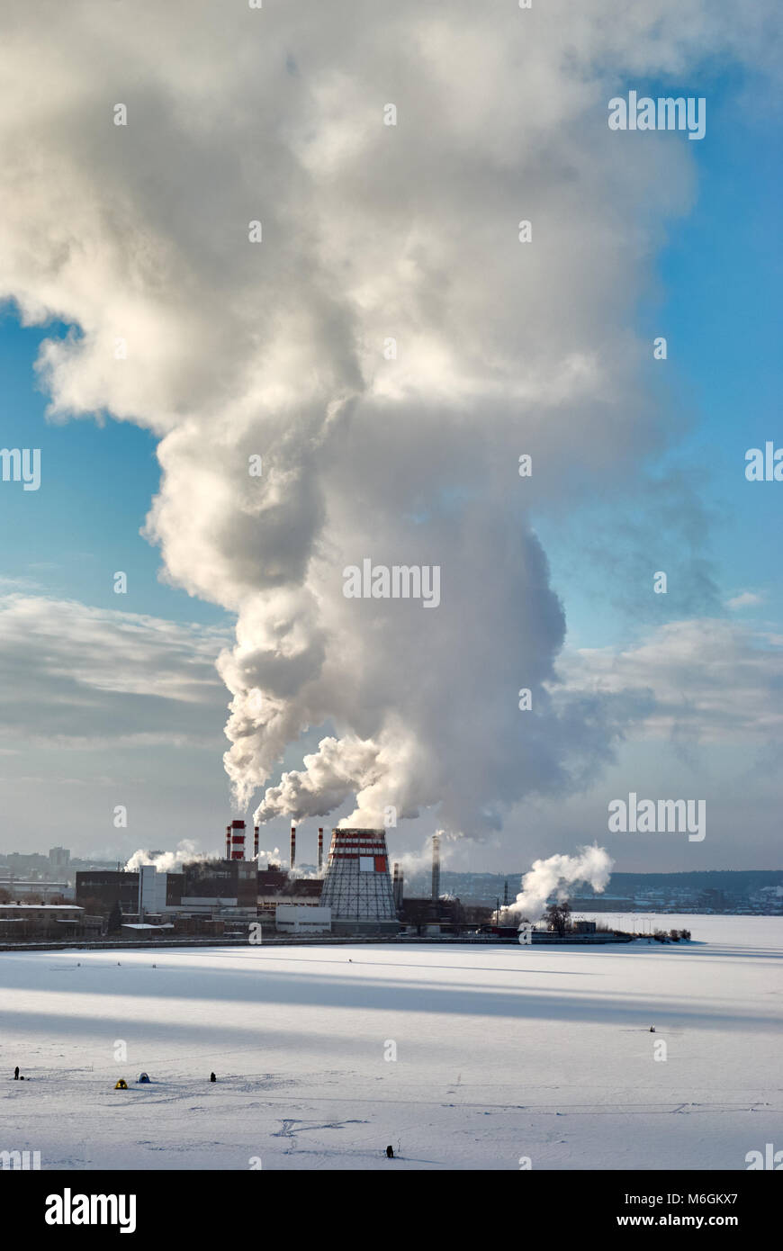 Dense steam escaping from a thermal power plant on a frosty day Stock