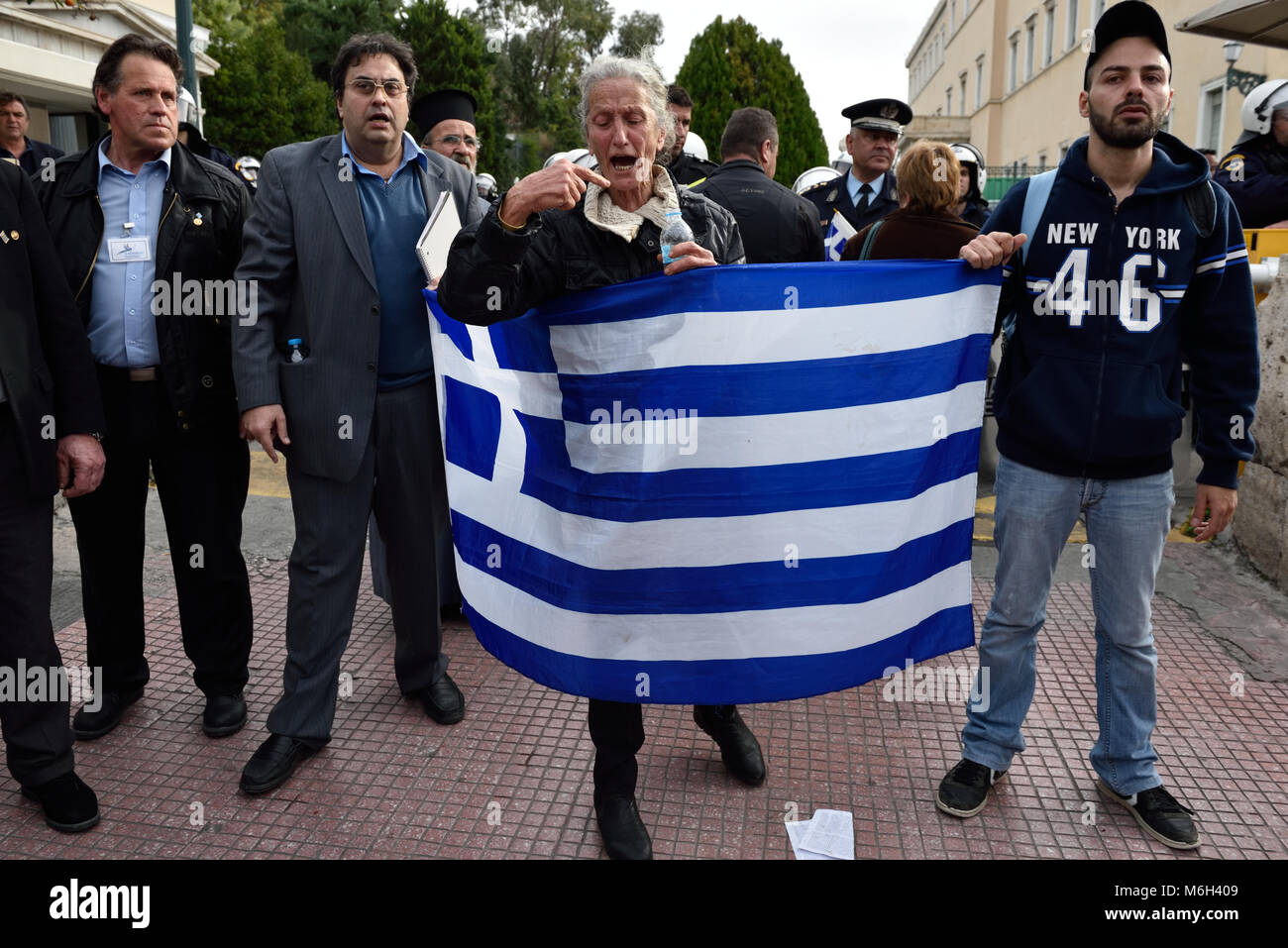 Protesters hold greek flag during hi-res stock photography and images ...