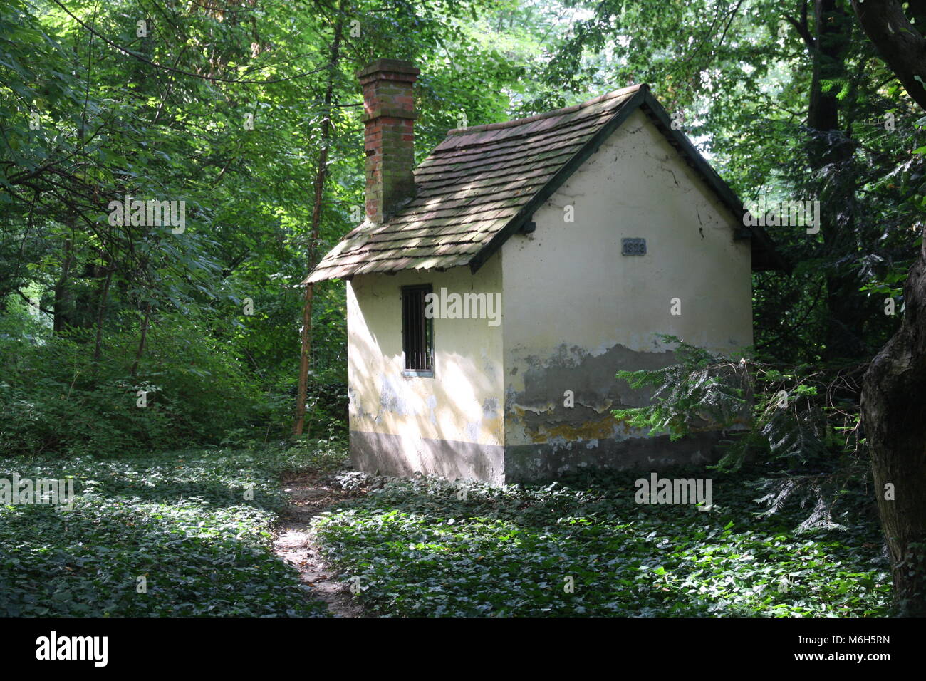 Old little hidden house in the hungarian wood. Stock Photo