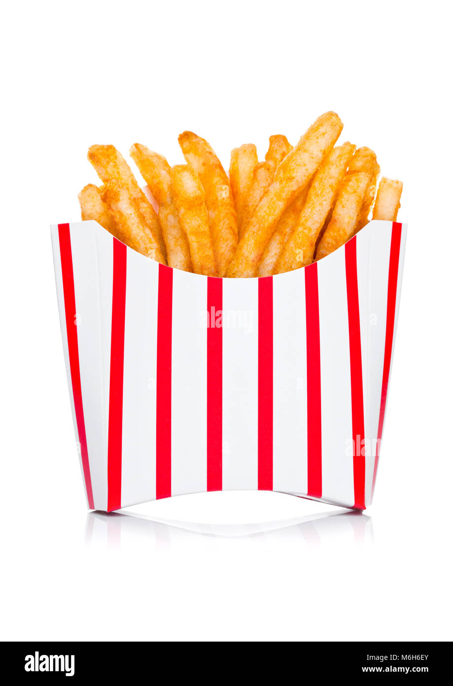 Southern french fries with paprika and salt in paper container on white