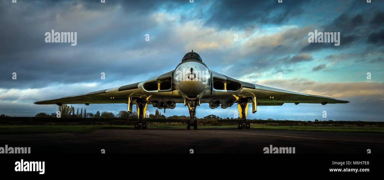 RAF Avro Vulcan Cold War V-Force nuclear bomber XM655 head on at dusk with low golden hour light Stock Photo