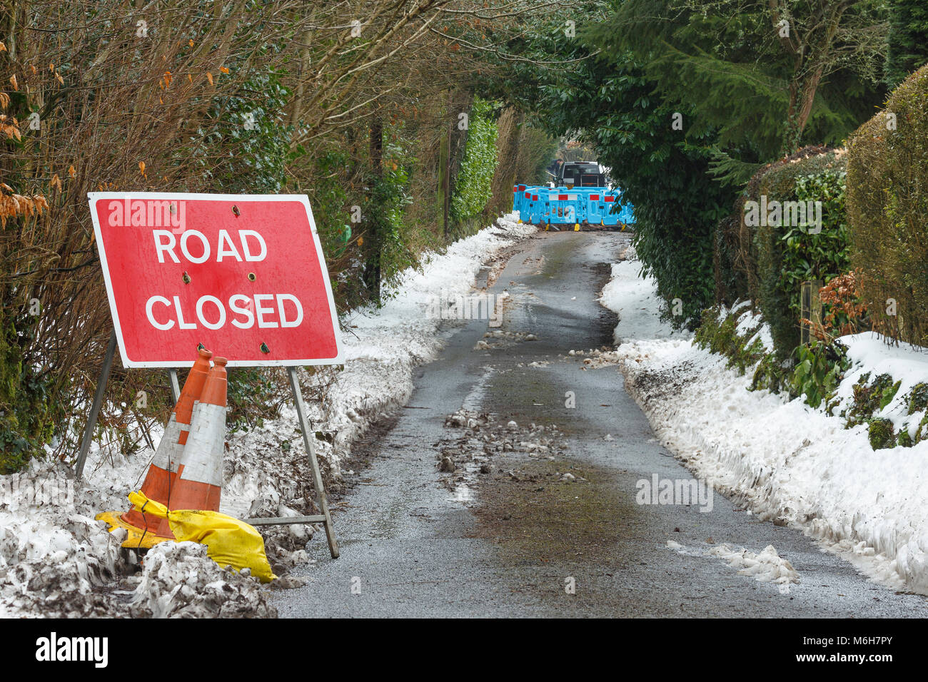 Road closure due to burst water main after heavy snowfall and freezing temperatures. Catbrook, Monmouthshire, Wales Stock Photo
