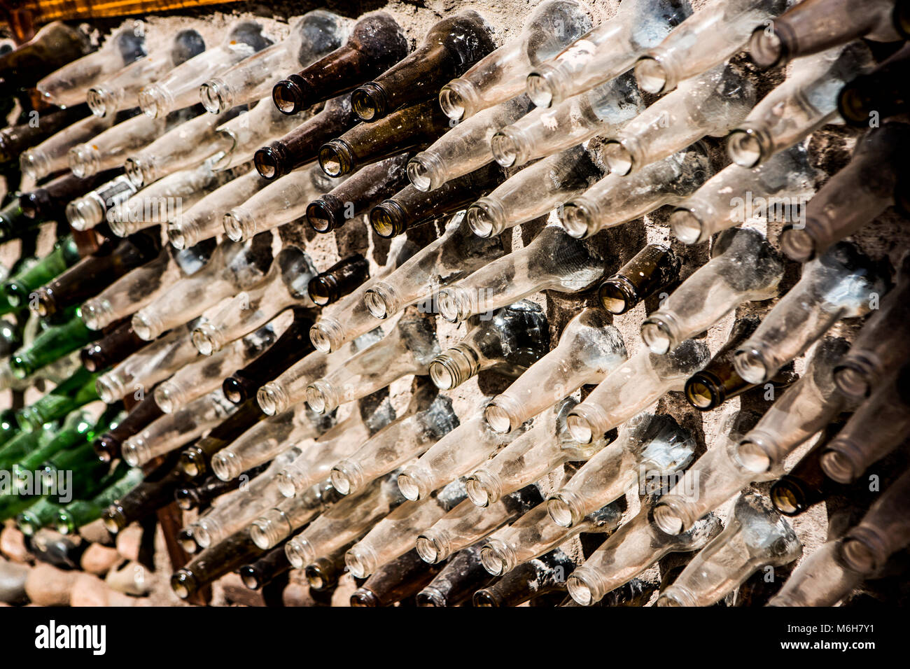 Glass bottles set in a wall in San Pedro de Atacama, Chile. Stock Photo