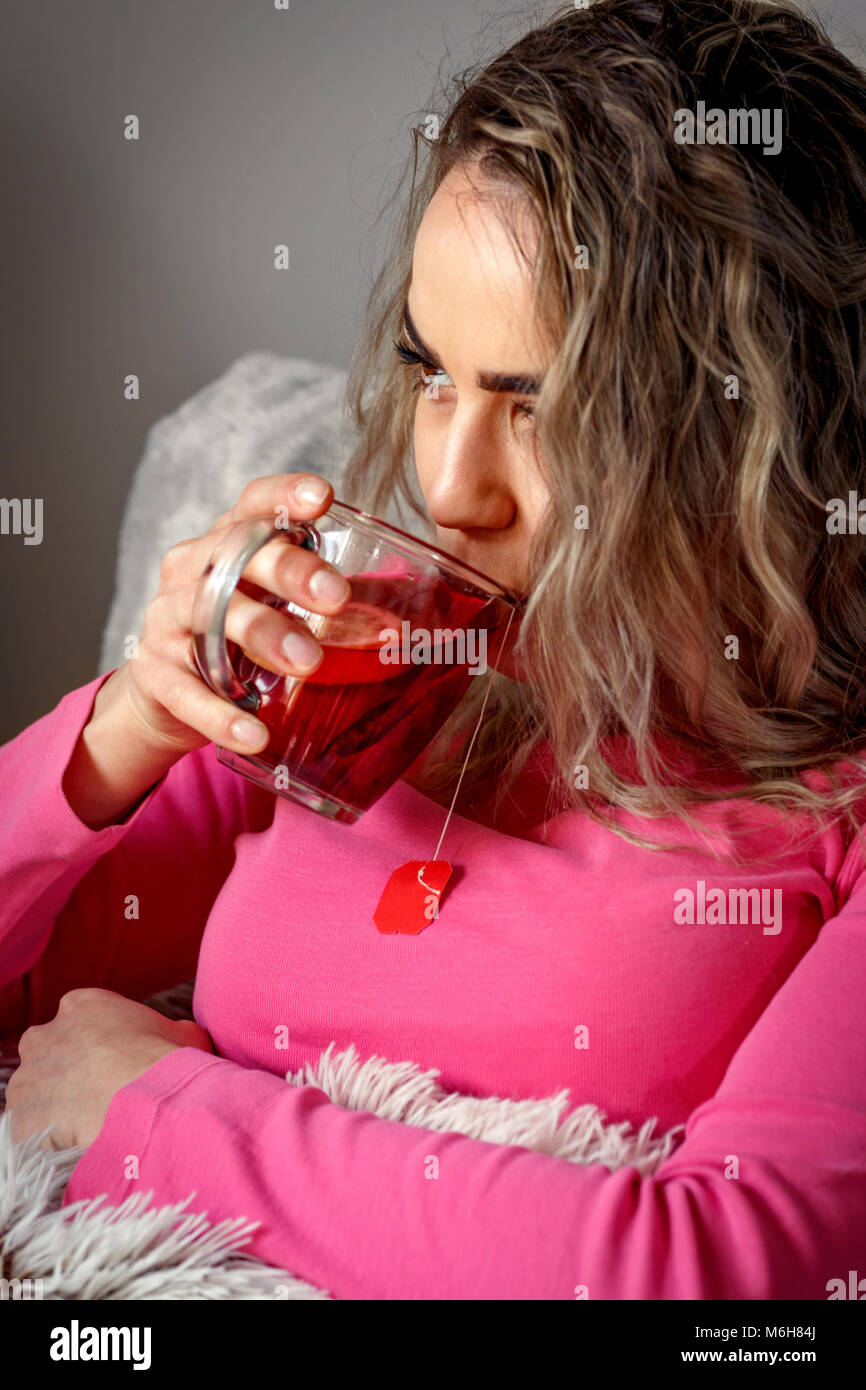 Sad woman drink tea headache hi-res stock photography and images - Alamy