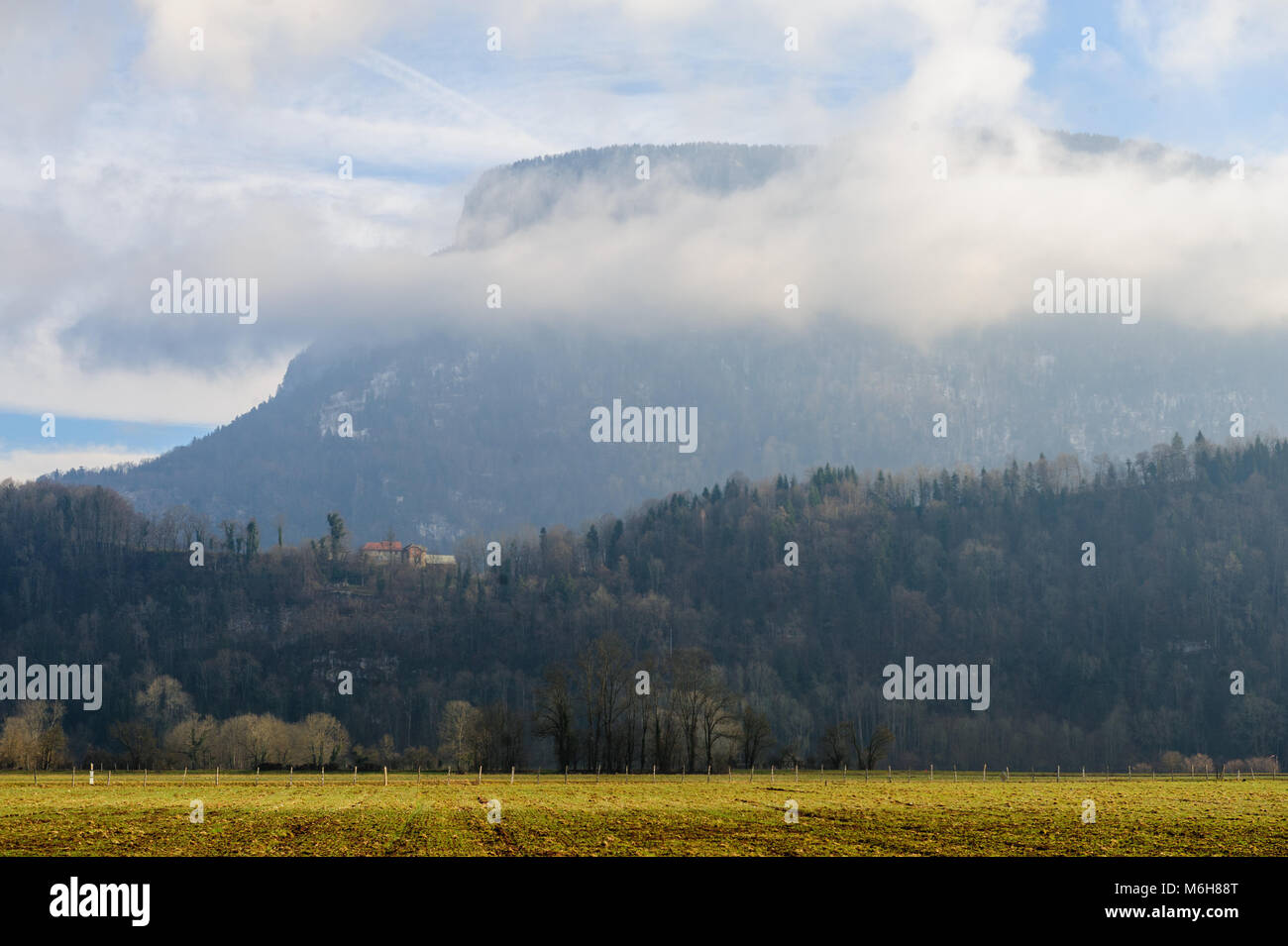 Mountain shrouded in clouds Stock Photo - Alamy