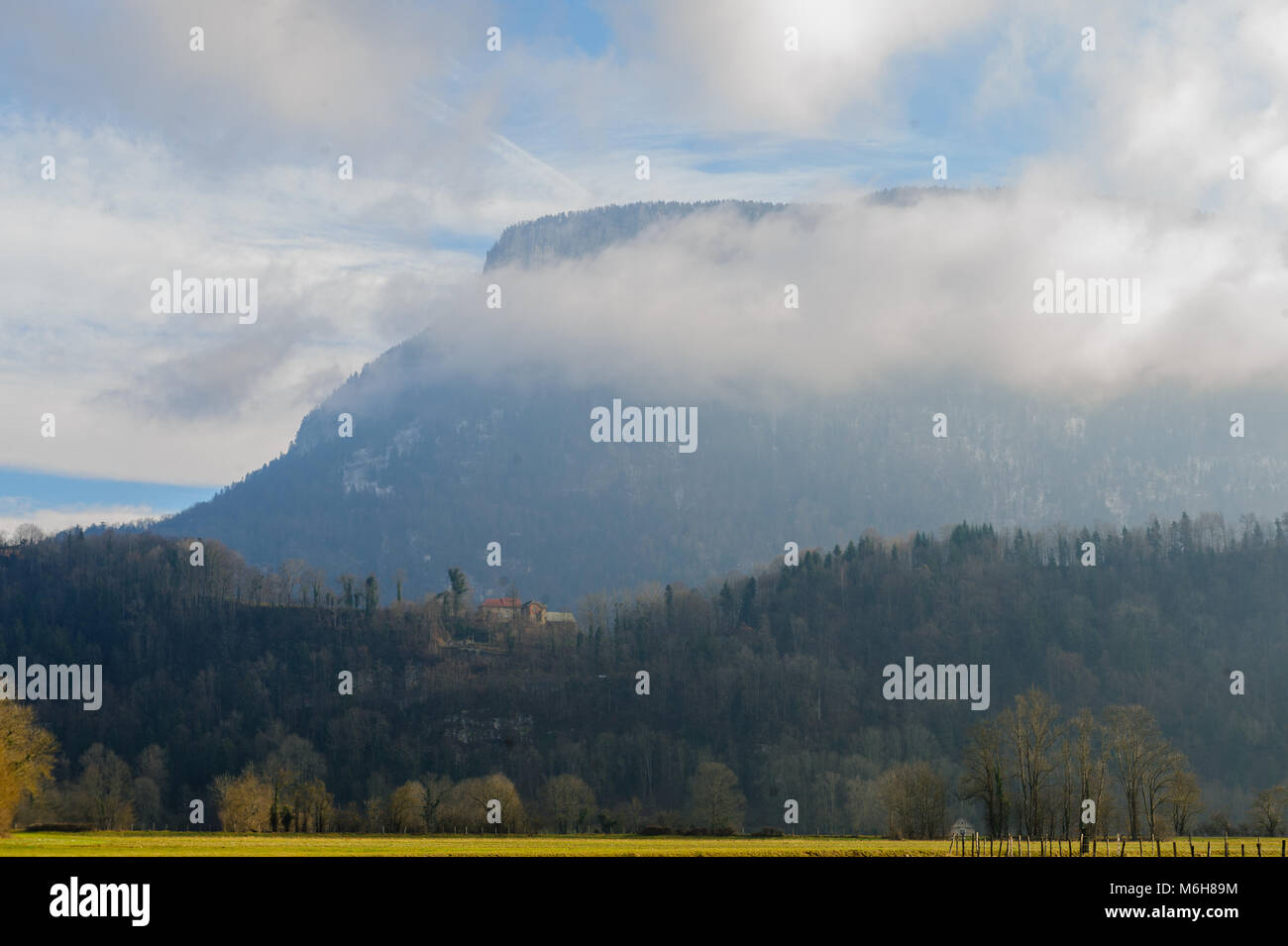 Mountain shrouded in clouds Stock Photo - Alamy