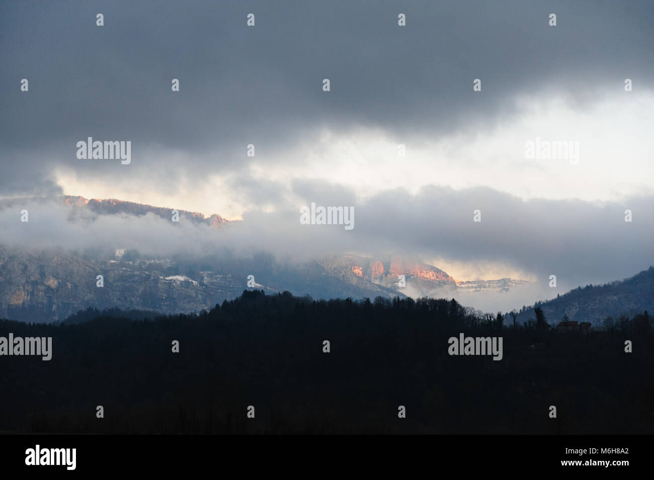 Mountain shrouded in clouds Stock Photo - Alamy