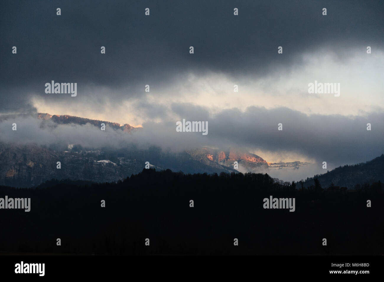 Mountain shrouded in clouds Stock Photo - Alamy