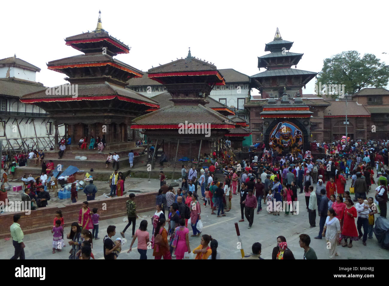 People in a crowded Durbar Square with visible damages after the earthquake, Kathmandu, Nepal Stock Photo