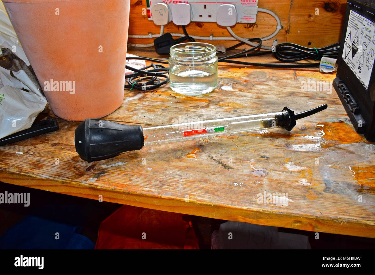 Hydrometer for testing the charge of a car battery. The height of the