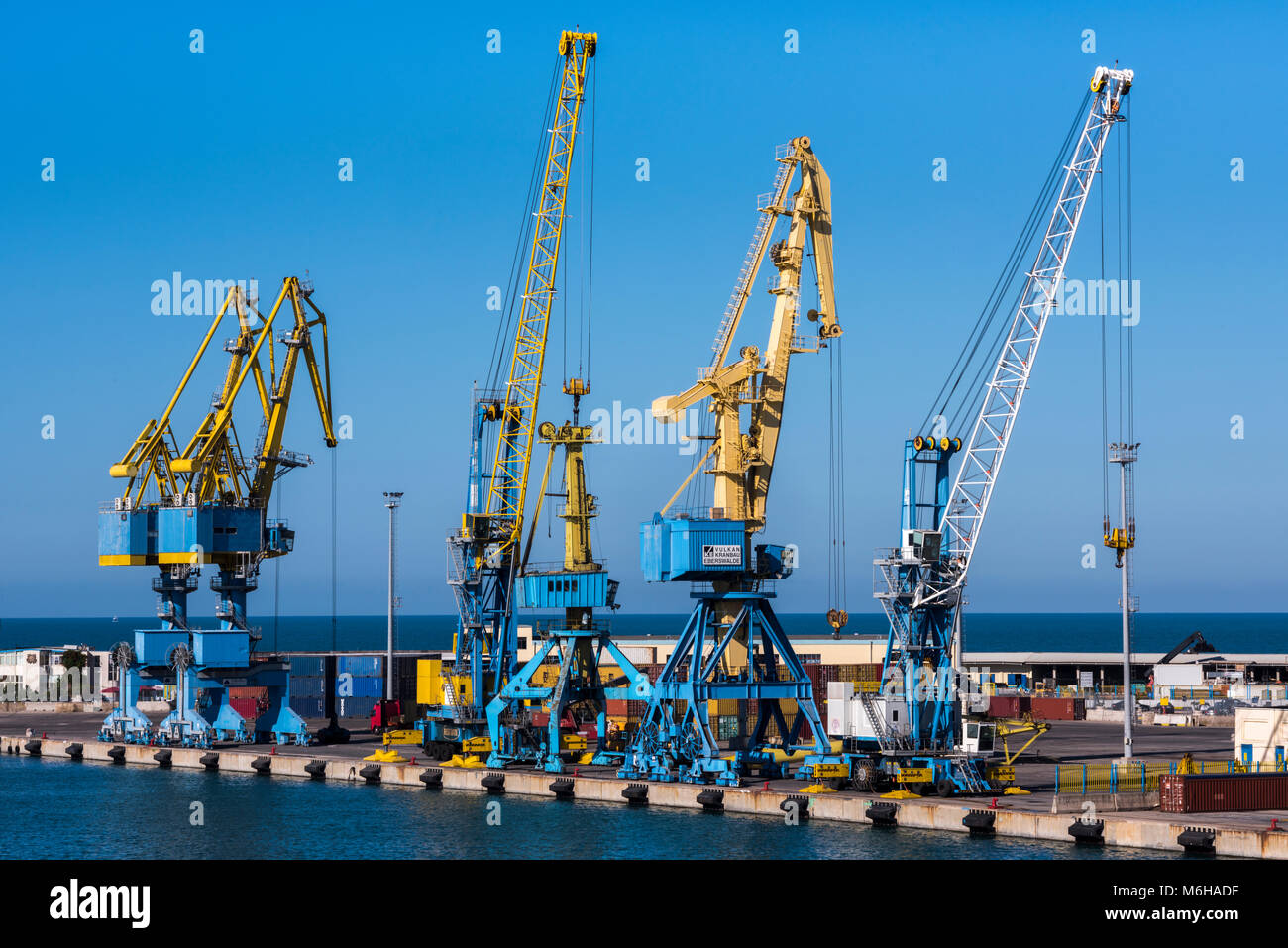 Durres, Albania - July 28, 2017: Cranes lined up in the harbor for loading containers for shippment Stock Photo