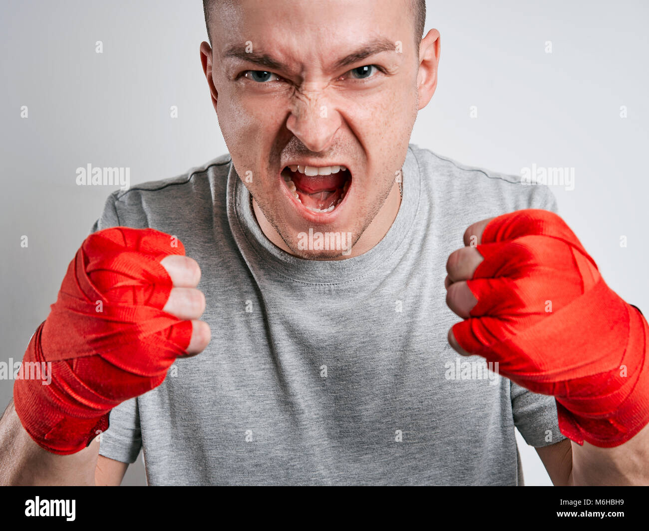 man in red Boxing bandages white background Stock Photo