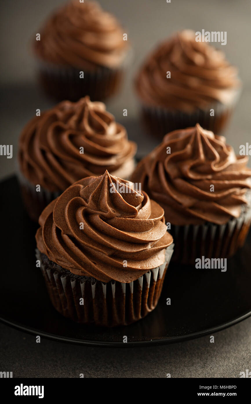 Dark chocolate cupcakes with ganache frosting Stock Photo Alamy