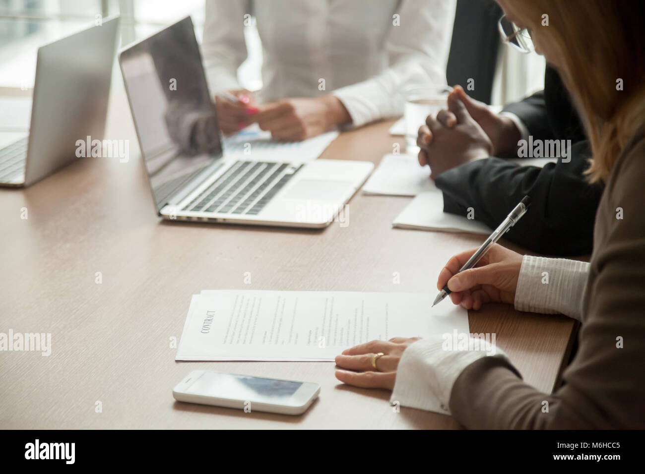 Businesswoman signing contract making deal with partners, close  Stock Photo