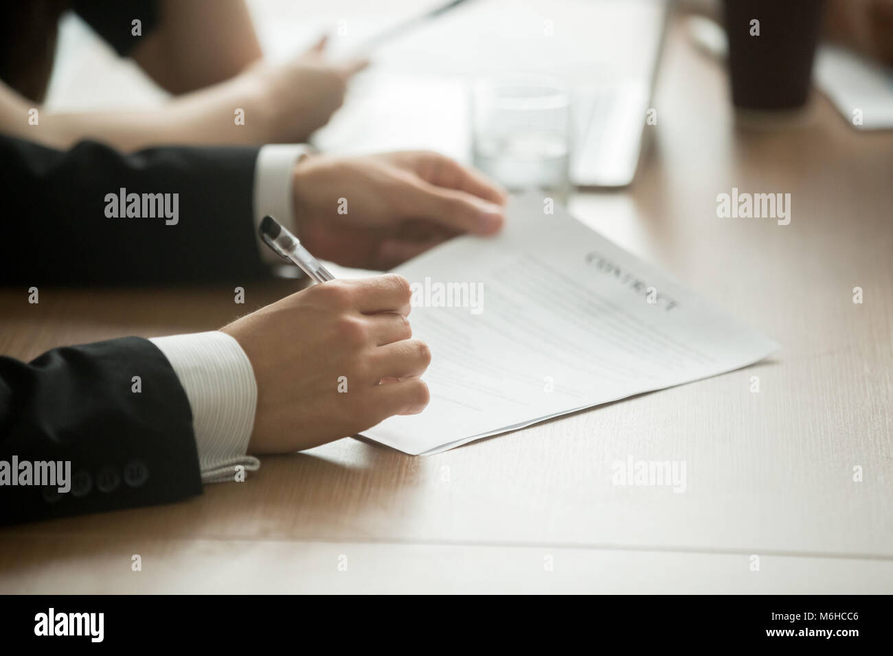 Businessman signing business contract concept, close up view Stock Photo