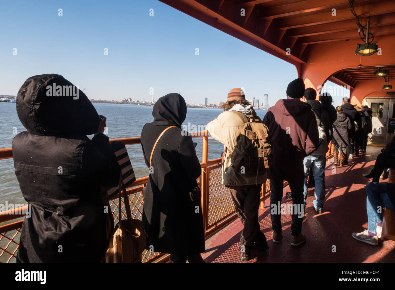 Tourists aboard the Staten Island Ferry in New York Harbor, NYC, USA Stock Photo