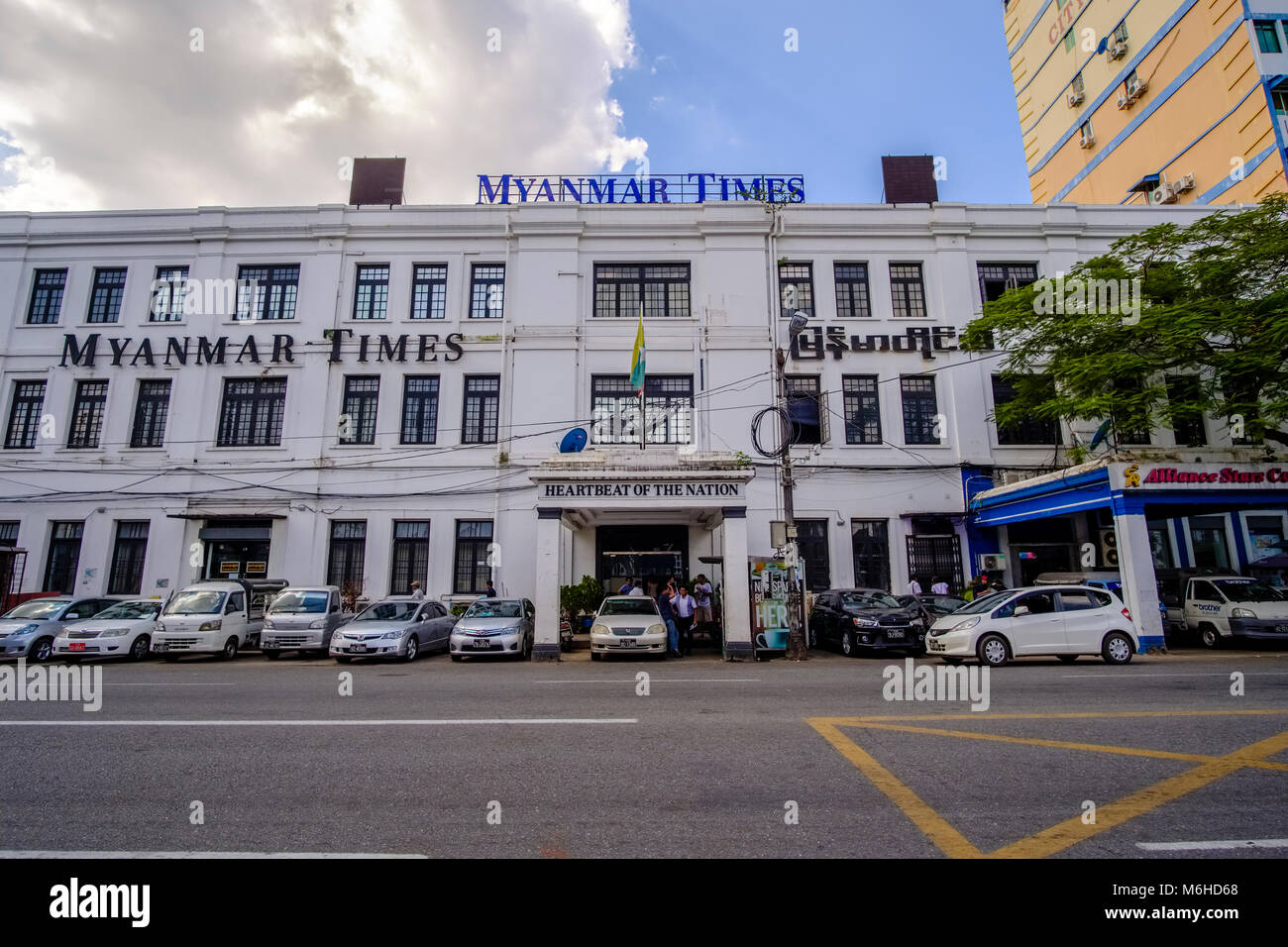 The colonial-era facade of the Myanmar Times building in the centre of town Stock Photo