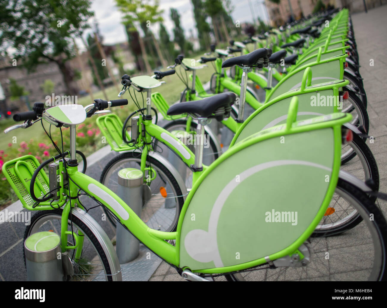 Row of new green public sharing bicycle lined up on the street , Modern concept of ecological transportation, Bike urban transport Stock Photo