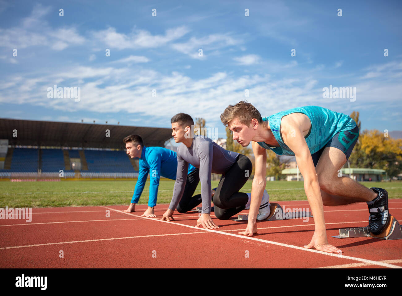 Athletes at the sprint start line in track and field Stock Photo Alamy