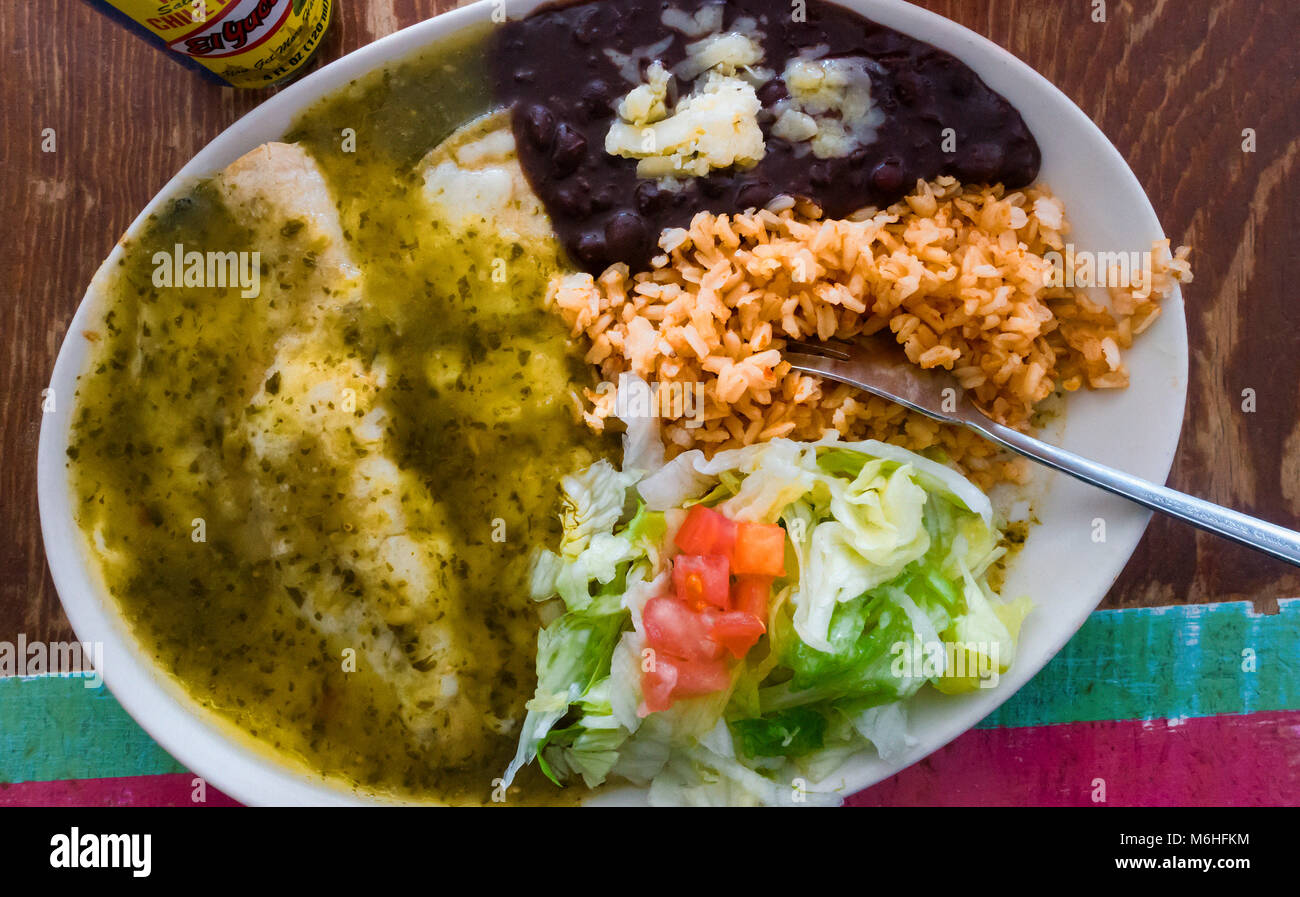 Enchiladas suizas with black beans, brown rice and salad Stock Photo ...
