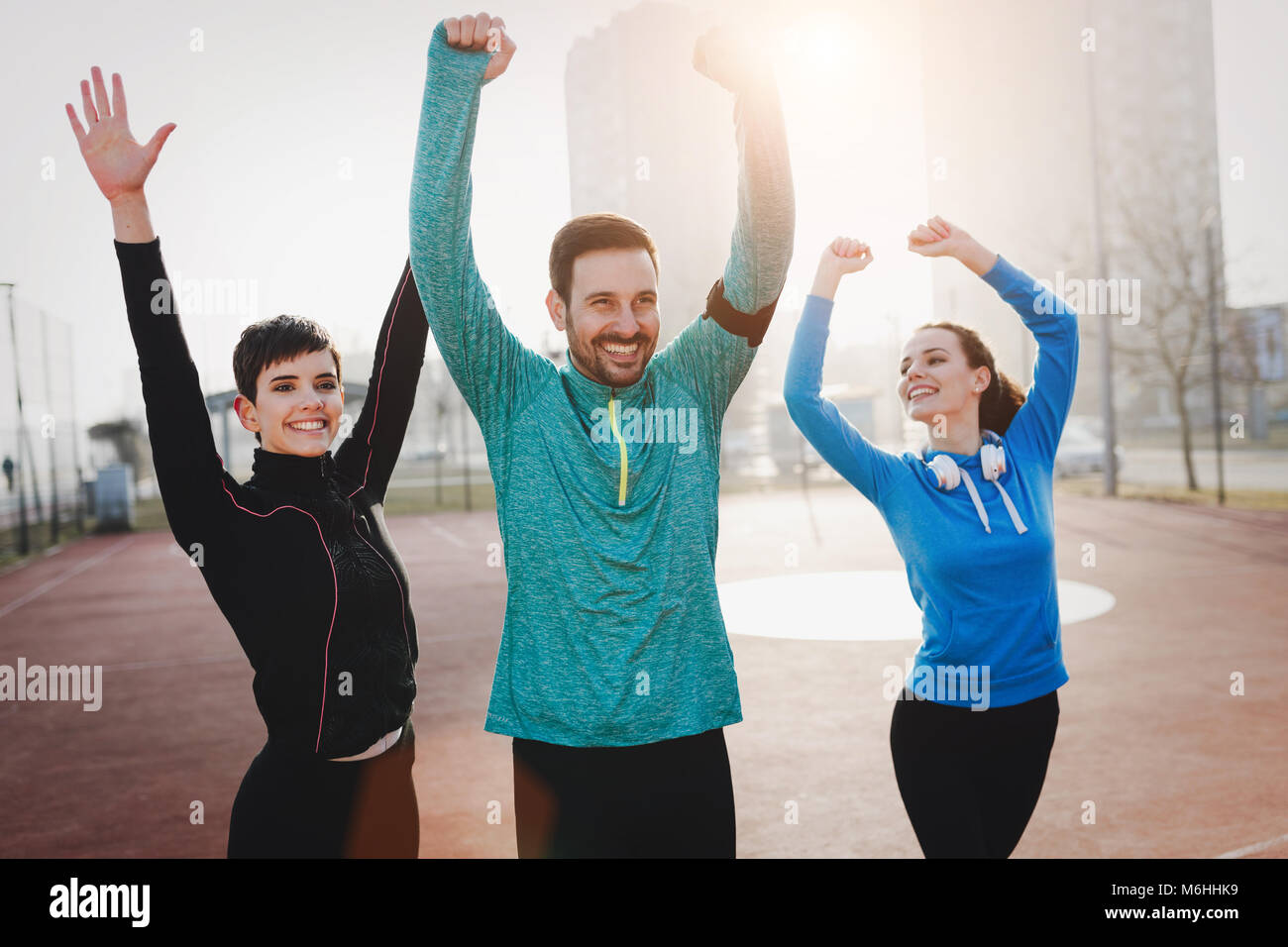 Friends fitness training together outdoors living active healthy Stock Photo