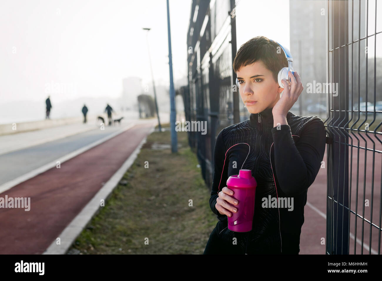 Attractive sportswoman exercising fitness and jogging outdoor Stock Photo