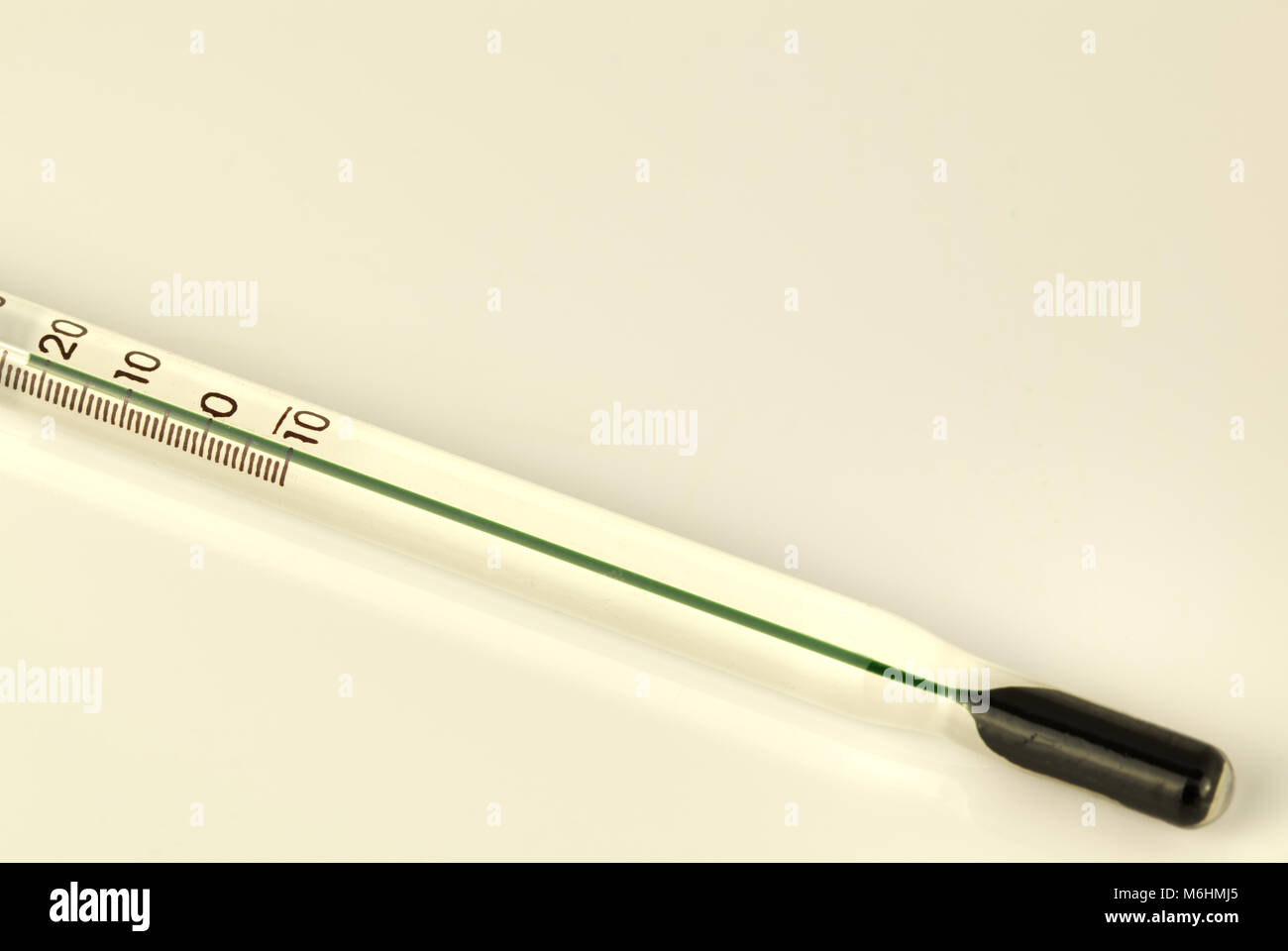 Green thermometer isolated on a white background. Scientific medical measuring device Stock Photo