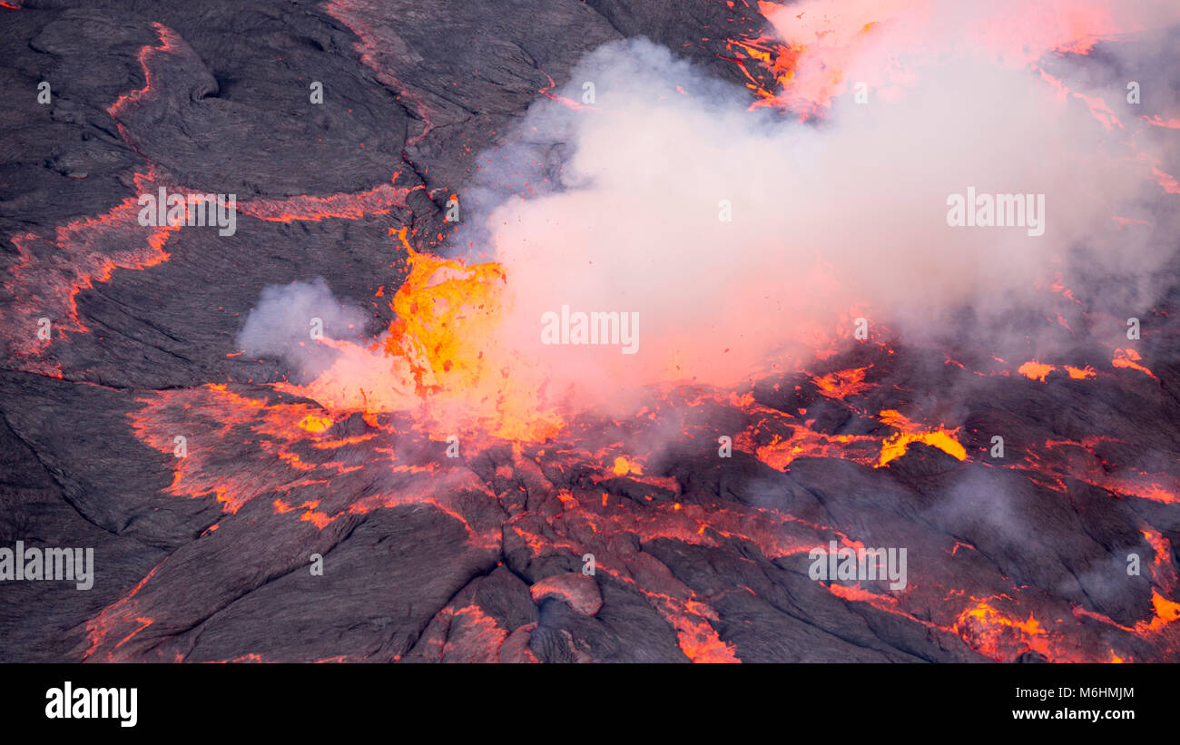 Lava bursts out of the worlds largest lava lake inside Nyiragongo in the Democratic Republic of Congo.  Taken 500 metres inside the active volcano. Stock Photo