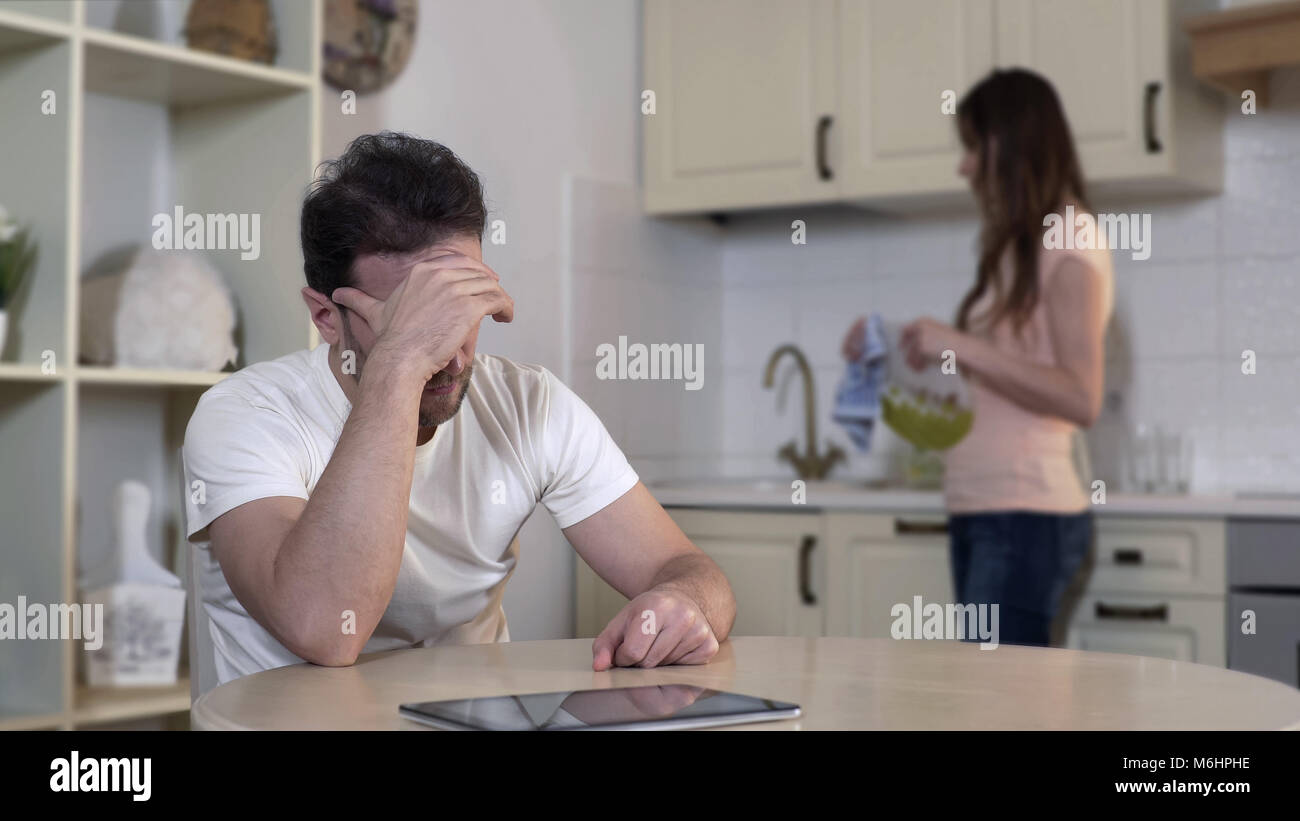 Nervous young woman quarreling with man, annoyed husband ignoring wife, breakup Stock Photo