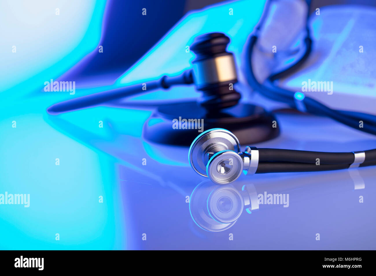 Medical law concept. Gavel, stethoscope, blue light. Place fort text. Stock Photo