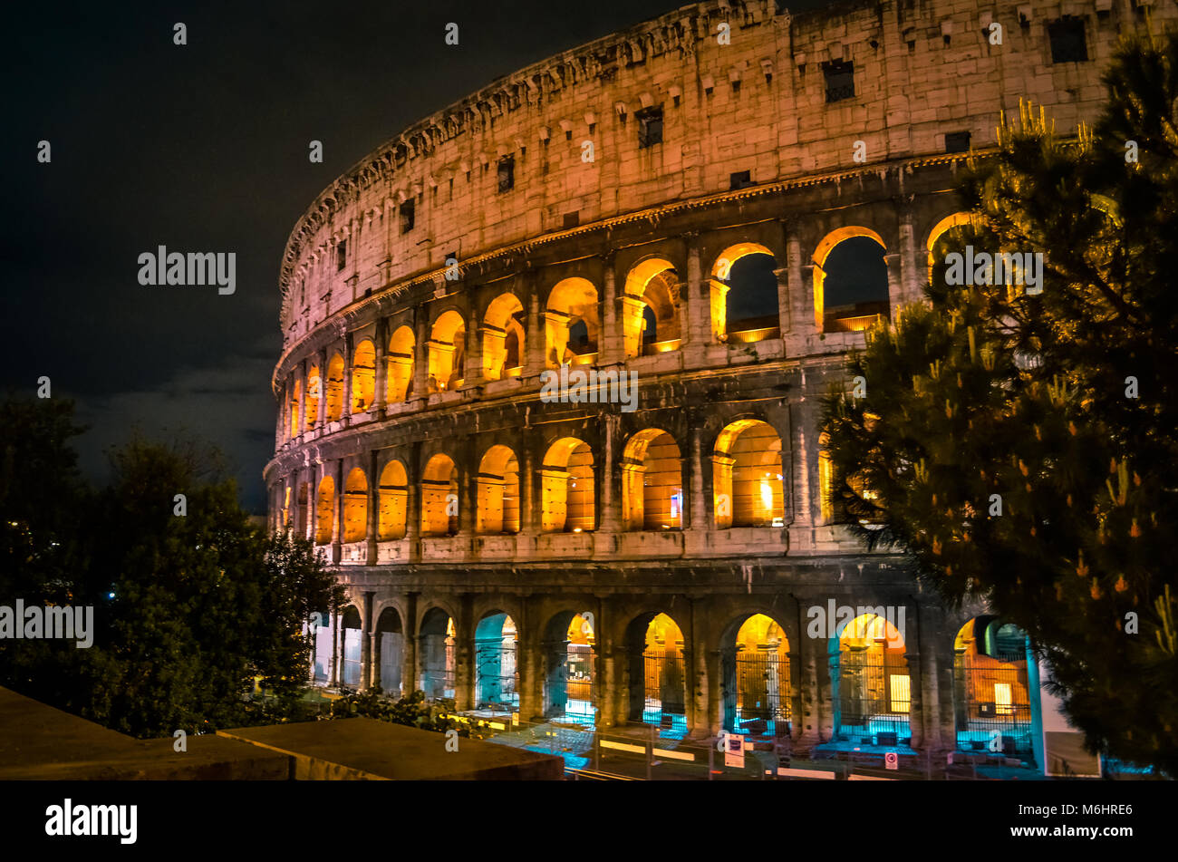 Illuminated Colosseum in night at Rome in Italy during summer time Stock Photo