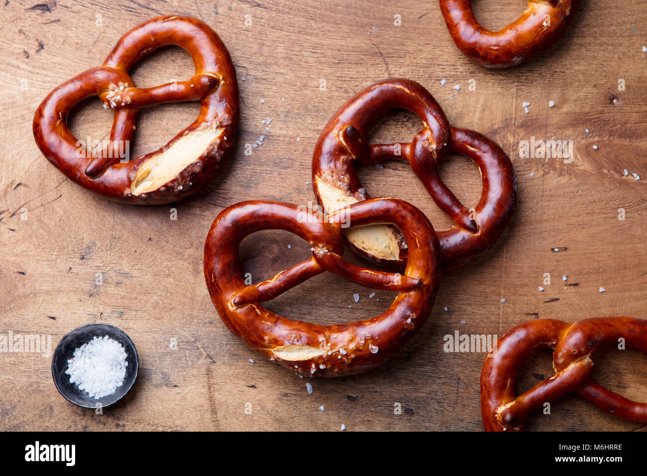 Salted pretzel on wooden background. Beer snack. Top view. Stock Photo