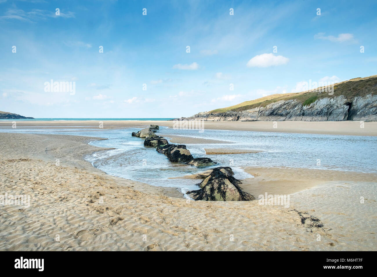 The River Gannel flowing across the beach at Crantock in Newquay Cornwall. Stock Photo