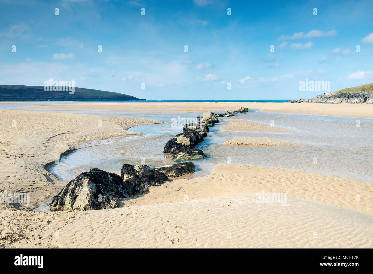 The Gannel River flowing across the beach at Crantock in Newquay Cornwall. Stock Photo