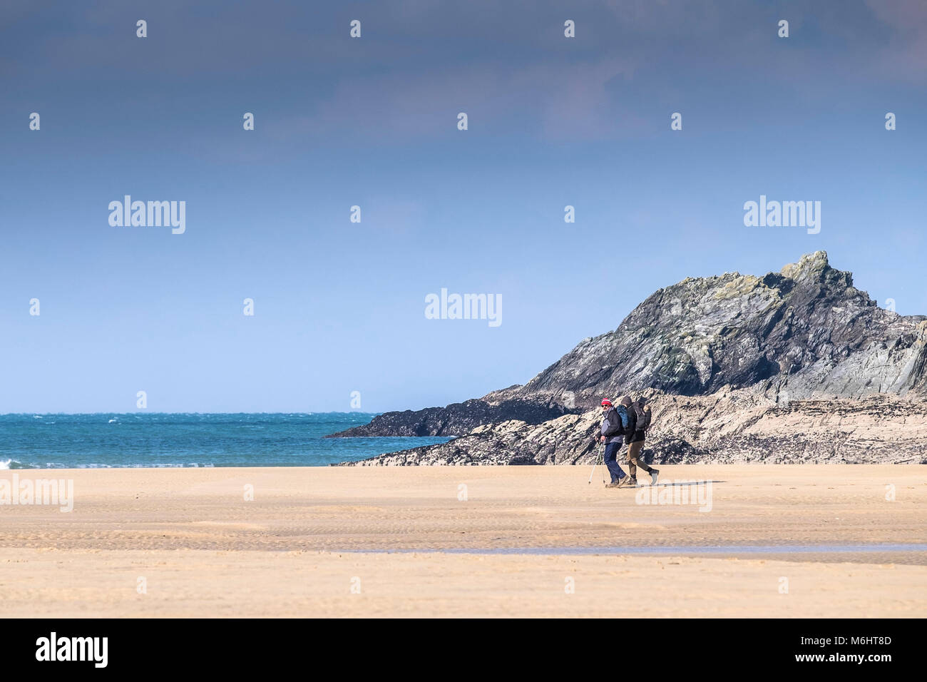 People walking across Crantock Beach in Newquay Cornwall. Stock Photo