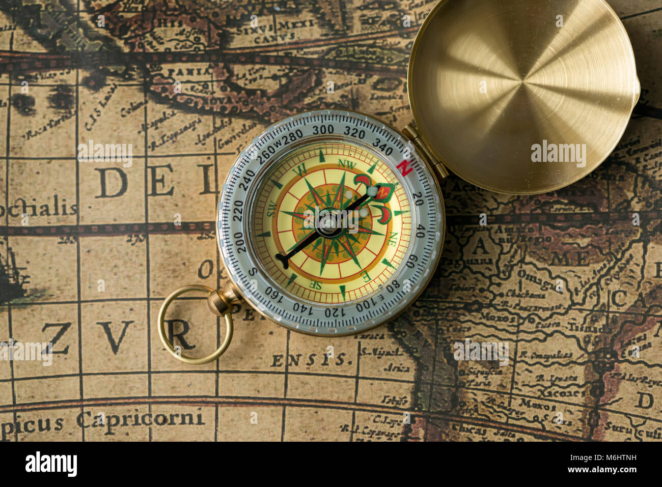 Old compass on ancient map hi-res stock photography and images - Alamy