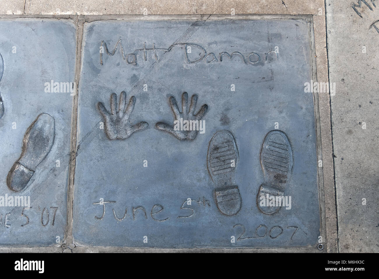 Handprints and footprints of the famous american actor Matt Damon on the ground behind the TCL Grauman's Chinese Theatre, Los Angeles, California. Stock Photo