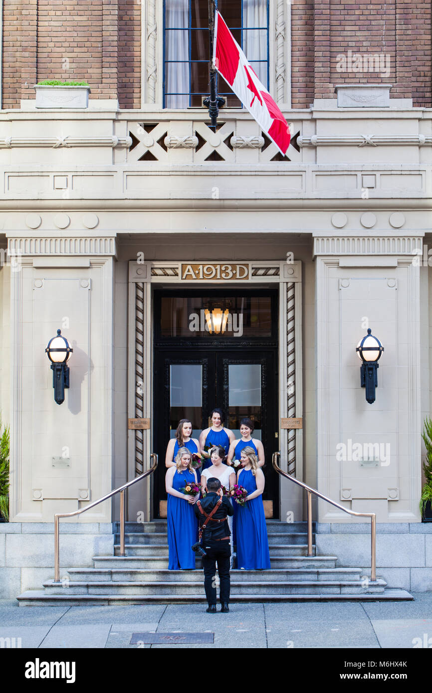 Bride and bridesmaids posing for a photographer in downtown Vancouver