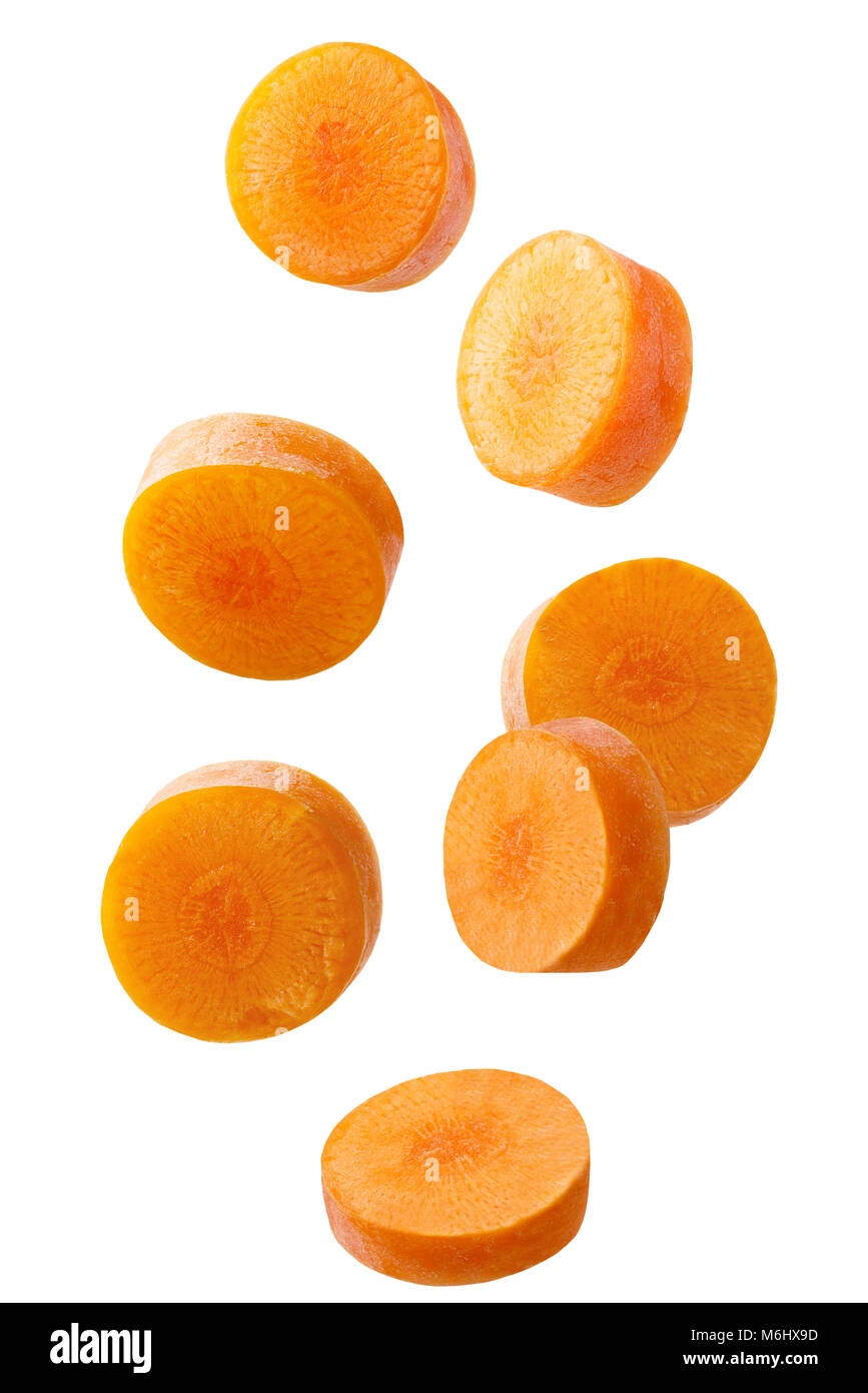 Isolated falling vegetables. Falling sliced carrot isolated on white
