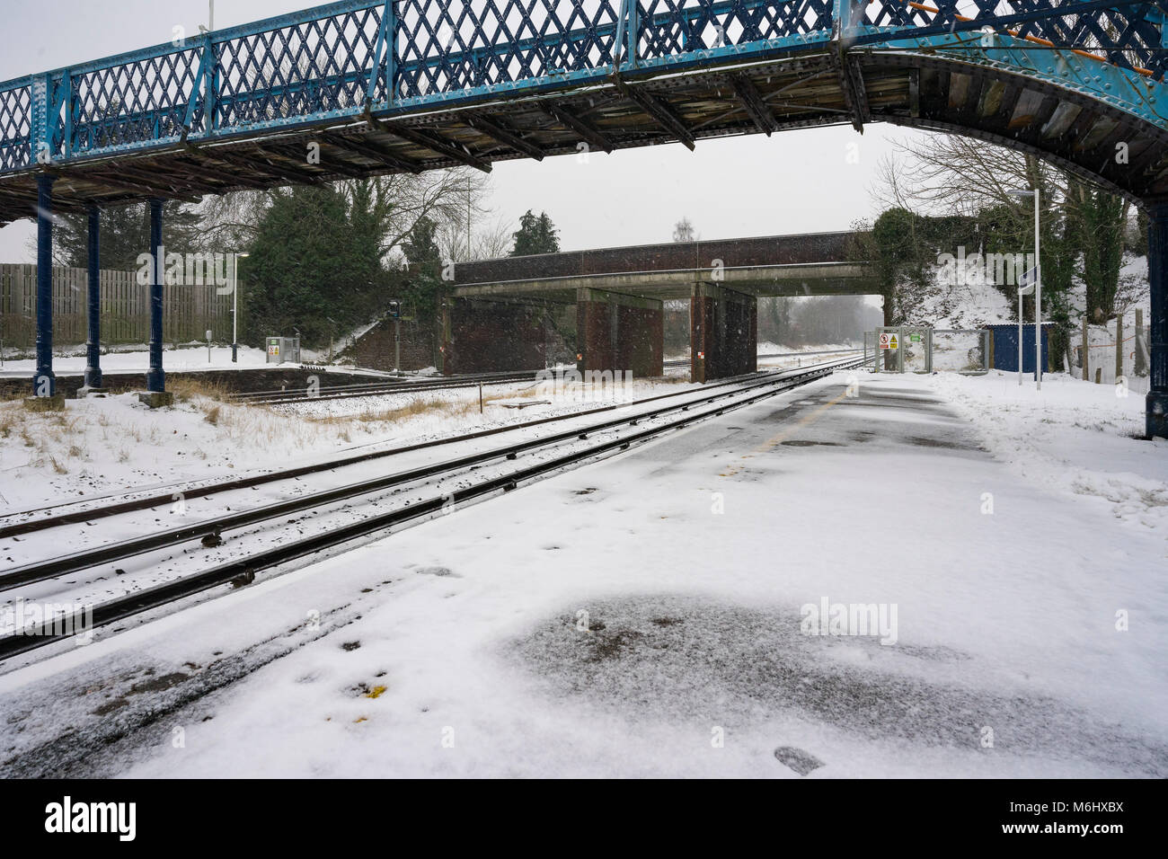 Mainline tracks through Hook Station in Hampshire during snowy weather Stock Photo