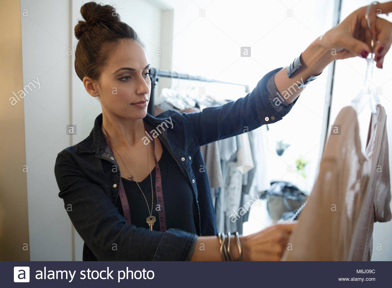 Female wardrobe stylist choosing shirt for photo shoot Stock Photo Alamy