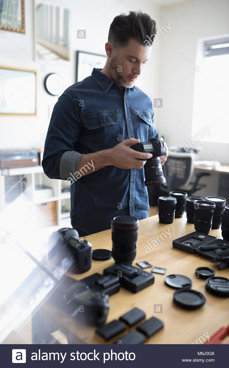Male photographer with digital camera and equipment Stock Photo Alamy