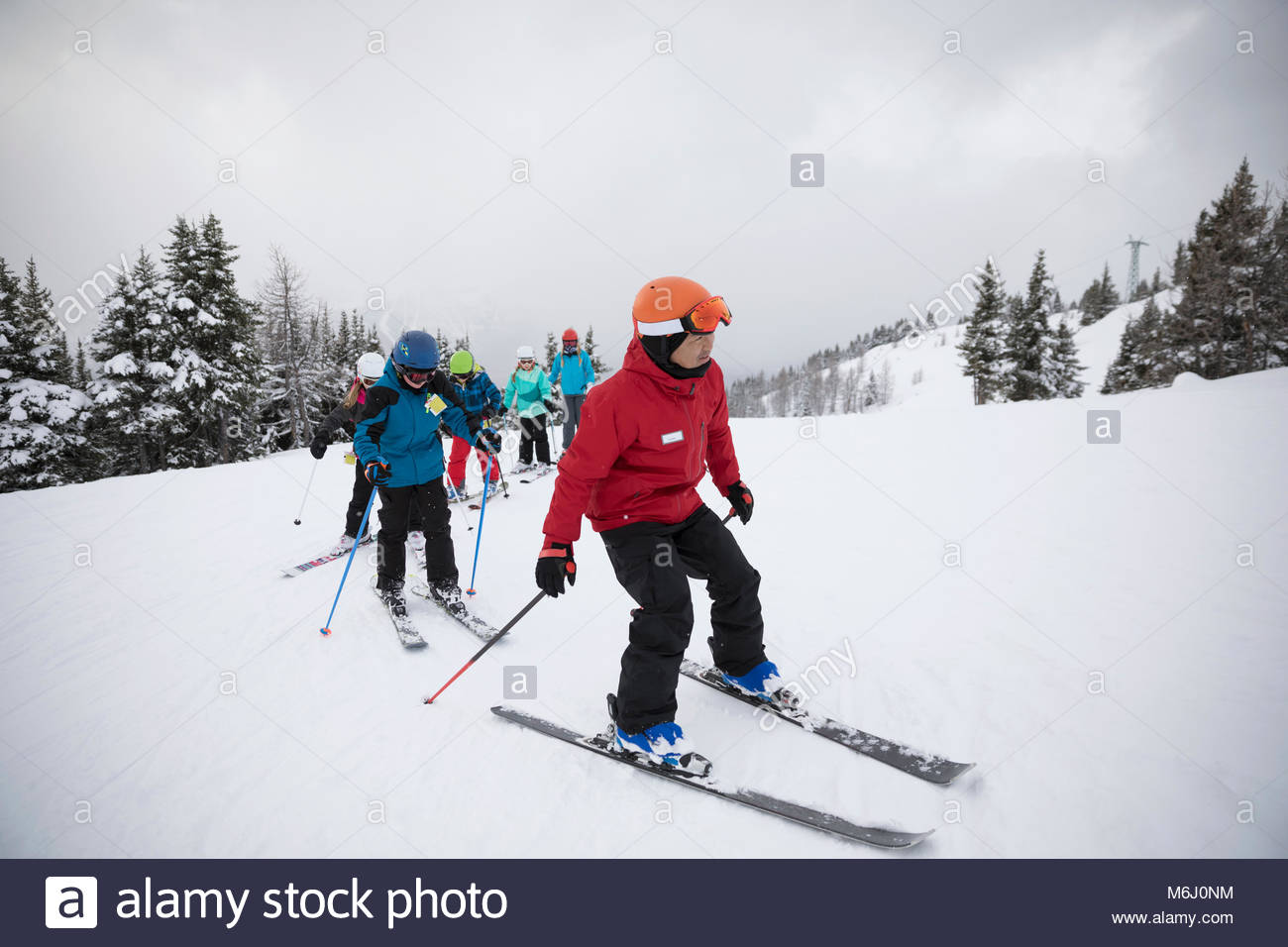 Instructor leading ski lesson for kids in snow Stock Photo Alamy