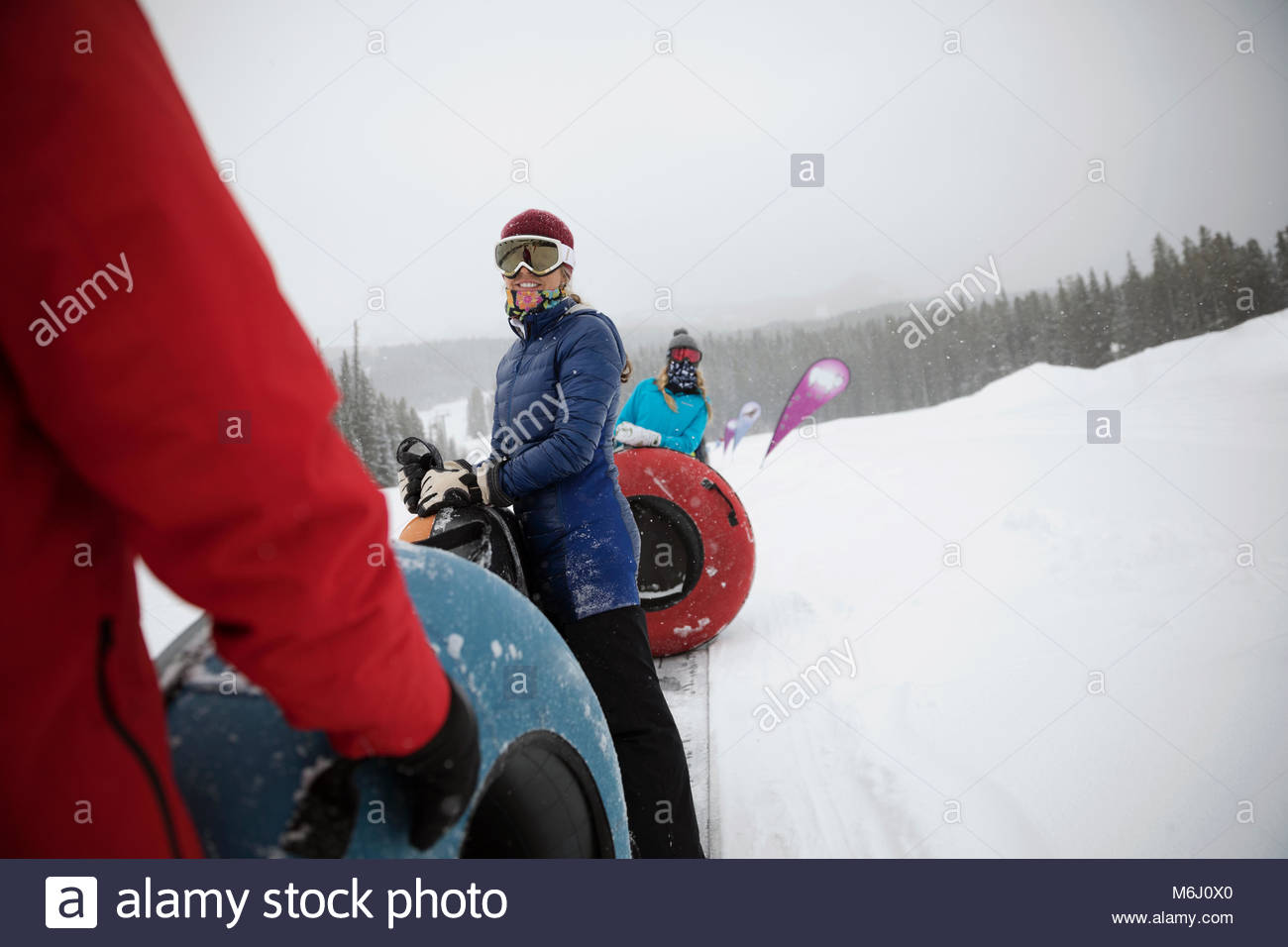 Family inner tubing in snow at tube park Stock Photo Alamy