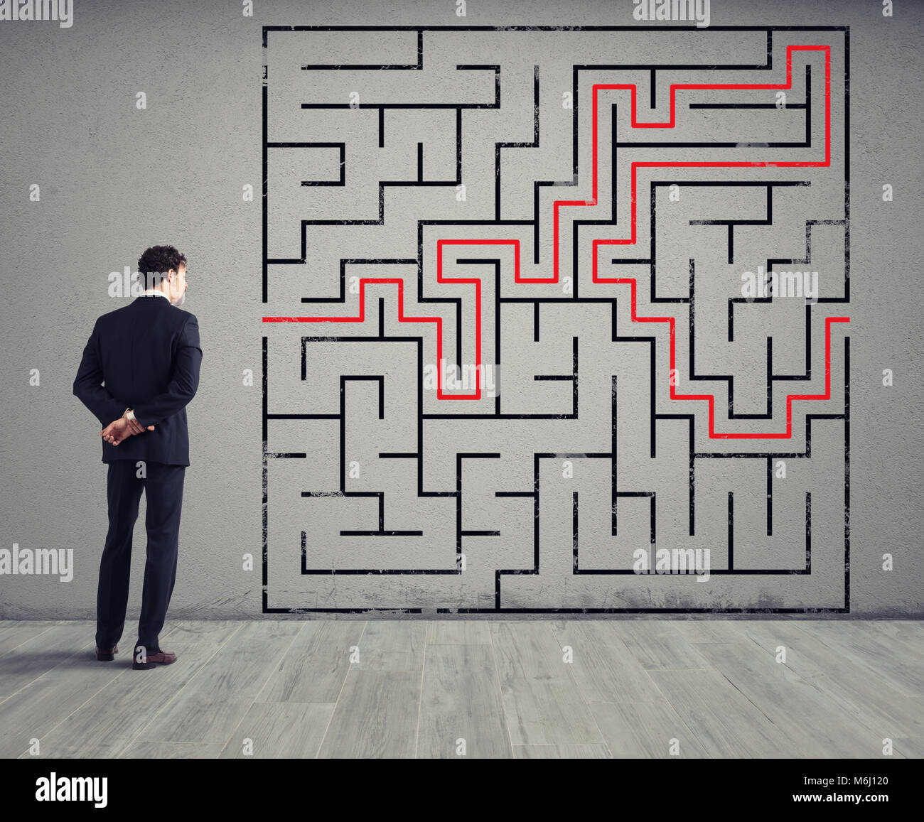 Businessman draws the solution of a labyrinth. Concept of problem solving Stock Photo