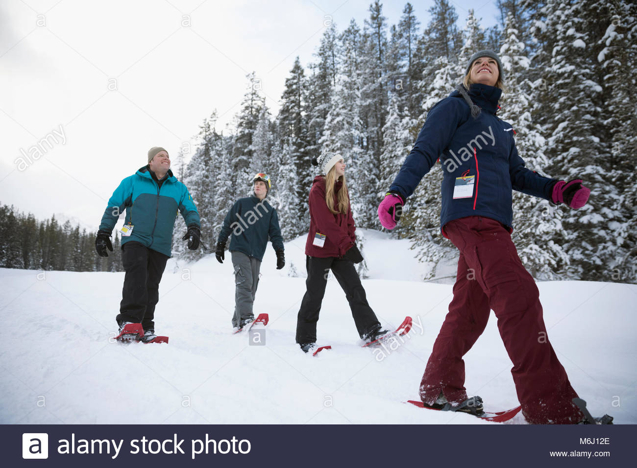 Family snowshoeing in snow Stock Photo Alamy