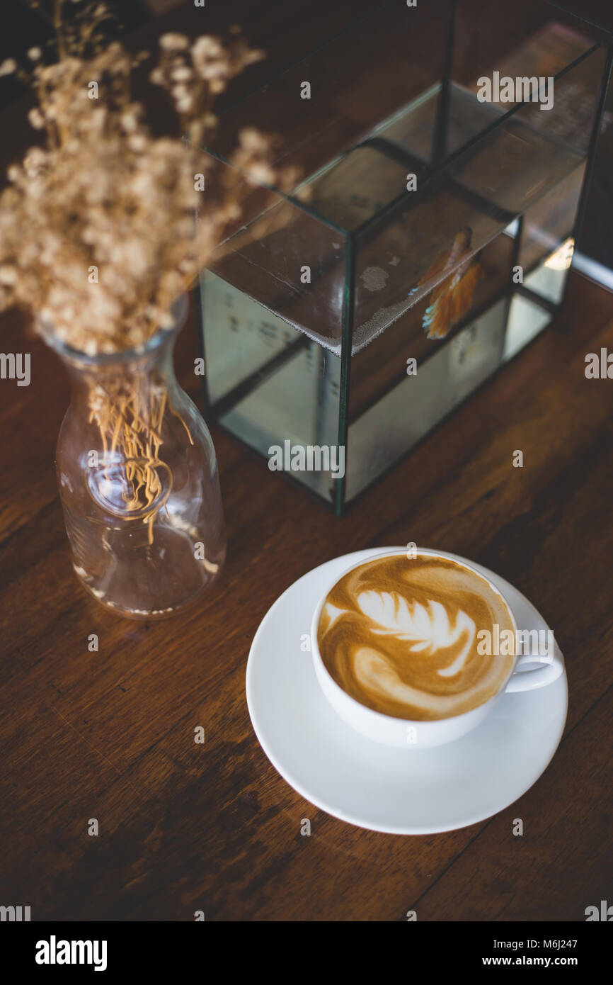 https://c8.alamy.com/comp/M6J247/a-cup-of-coffee-latte-or-cappuccino-on-wood-table-with-decoration-M6J247.jpg